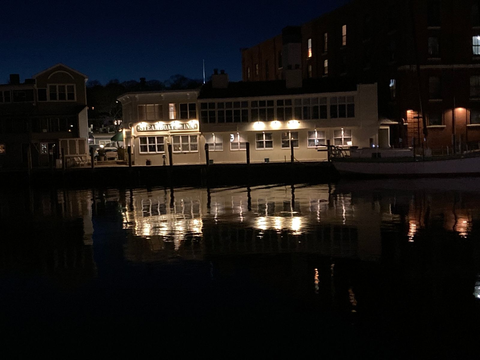 Steamboat Inn Mystic CT waterfront rooms at night