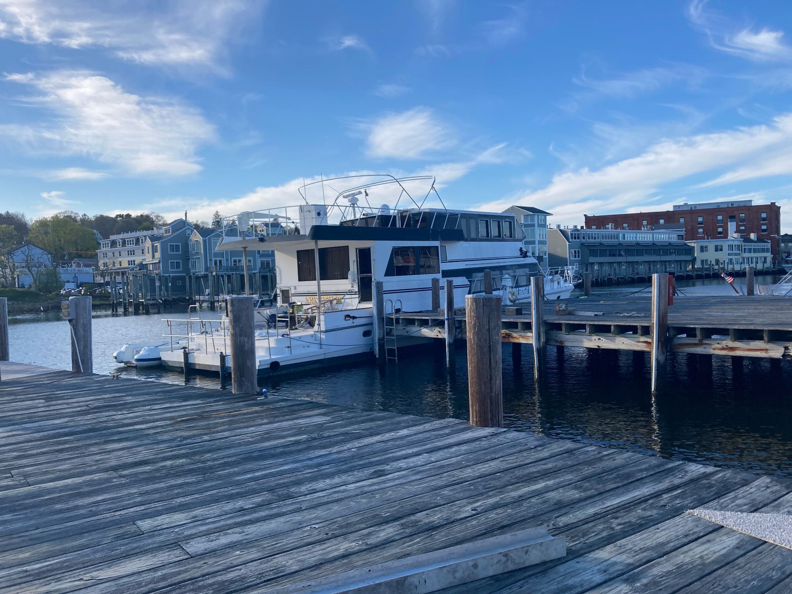 Yacht and working dock on the Mystic River on a clear day